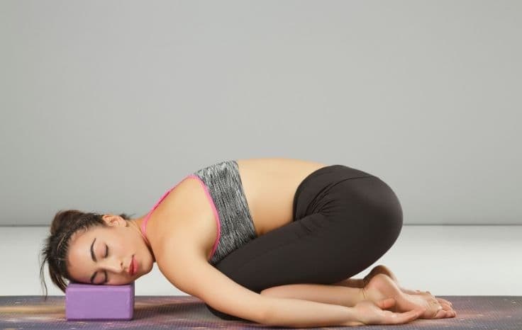 child's pose with blocks