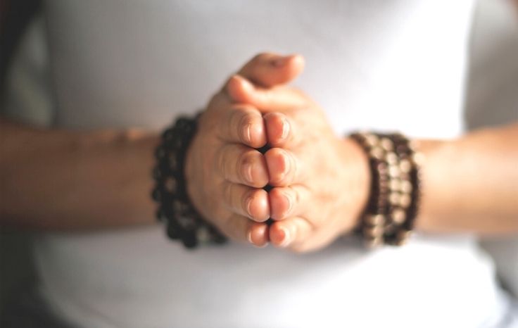 hands with mala beads
